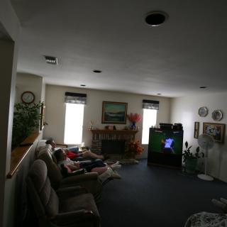 A cozy living room with a television, fireplace, and comfortable seating.