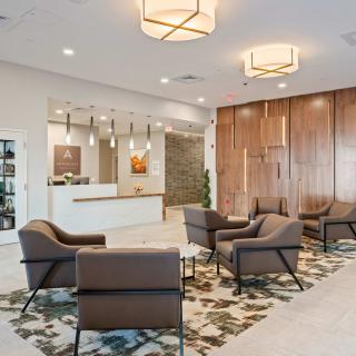 Modern lobby with comfortable seating and a reception desk.