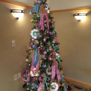 A beautifully decorated Christmas tree adorned with colorful ribbons and ornaments.