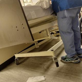 A healthcare professional attending to a patient in a hospital setting.