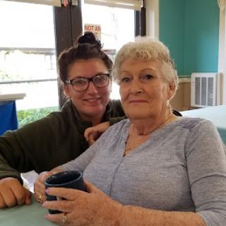 A heartwarming moment between two generations at a cozy cafe.