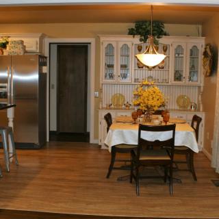 A cozy dining area with a classic table and chairs, adjacent to the kitchen.