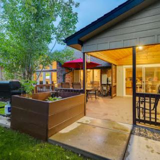 A cozy backyard patio with warm evening lights, perfect for relaxation and outdoor gatherings.