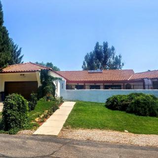 A suburban house with a garage, driveway, and well-maintained yard.