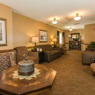 A cozy living room with sofas, a coffee table, and warm lighting.