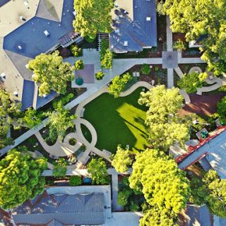 A beautiful aerial view of a landscaped neighborhood featuring winding paths and lush greenery.
