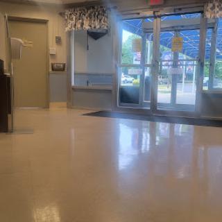A bright and clean lobby area with large windows allowing natural light in.