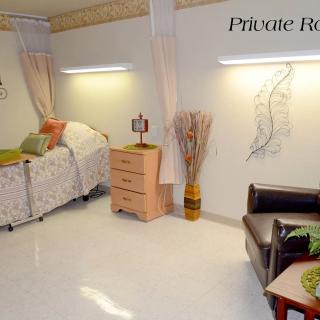 A clean and well-furnished private hospital room.