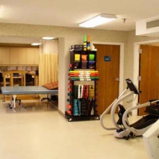 A physical therapy room equipped with exercise machines and supplies.