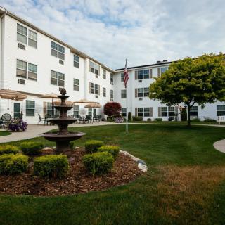 A well-maintained residential courtyard with a fountain and garden.