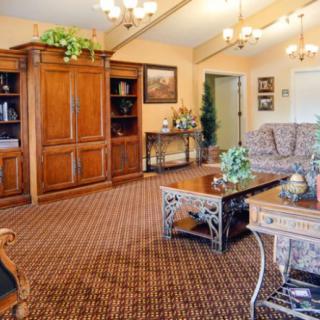 A cozy living room with elegant wooden furniture and a warm color palette.
