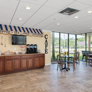 A small cafe area with a coffee station and seating.