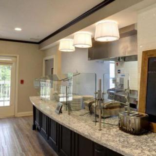 Modern kitchen interior with a sleek countertop and stylish lighting.