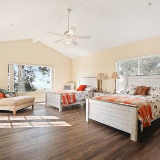 Spacious bedroom with elegant furniture and natural light.