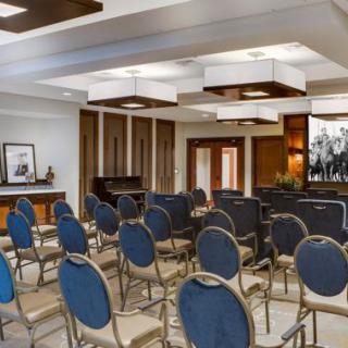 A well-organized conference room with rows of chairs arranged for a meeting.