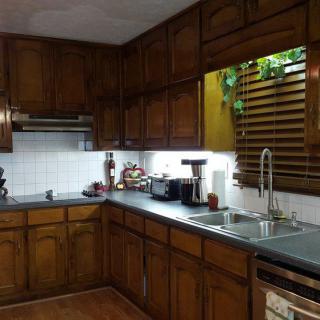 A cozy kitchen with wooden cabinets and modern appliances.