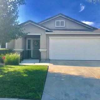 A modern suburban house with a two-car garage and a well-maintained front lawn.