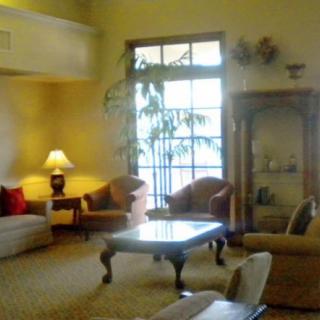 A cozy living room with comfortable seating and warm lighting.