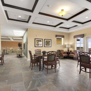 A spacious and contemporary dining area with elegant seating and a coffered ceiling.