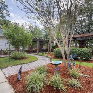 A beautifully landscaped garden with a winding pathway and decorative elements.