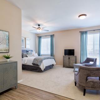 A modern and cozy bedroom with stylish decor and ample natural light.