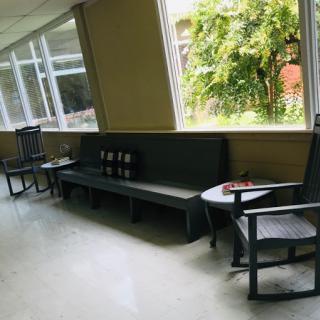 A cozy waiting area featuring comfortable seating and natural light streaming through the windows.