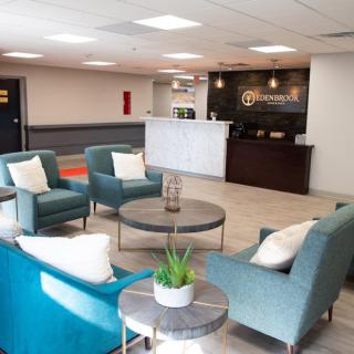 A modern lobby with comfortable seating and a reception desk.