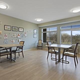 A modern dining area with large windows and minimalist decor.