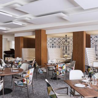 A modern restaurant interior with neatly arranged tables and chairs.