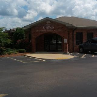 A brick building with an inviting entrance under a cloudy sky.