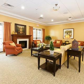 A cozy living room with a fireplace, comfortable sofas, and elegant decor.