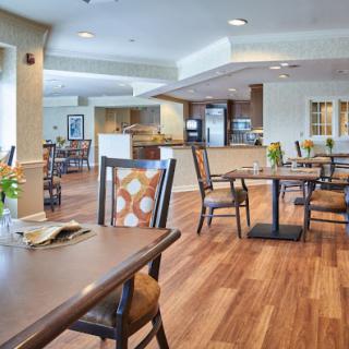 A spacious and inviting dining area with wooden floors and modern furnishings, perfect for casual meals.