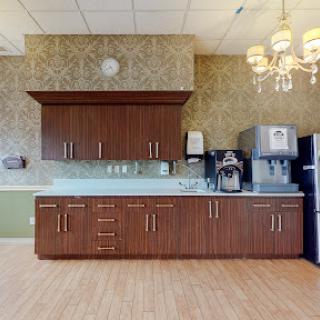 A modern kitchen setup featuring wooden cabinetry and contemporary appliances.