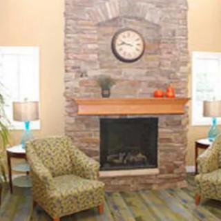 Cozy living room with a stone fireplace and comfortable seating.