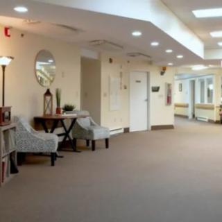 A well-lit hallway with a seating area and decorative elements.