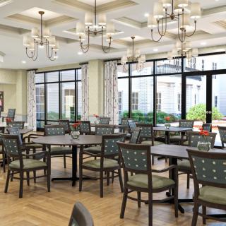 A spacious dining room with elegant chandeliers and large windows.