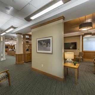A modern office interior featuring seating areas and elegant lighting.