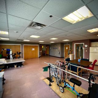 A spacious rehabilitation therapy room equipped with various physical therapy tools, ready for patient use.