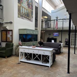 A spacious indoor lobby featuring modern furniture, an aquarium, and a cozy seating area.