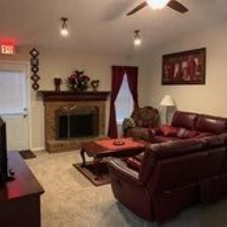 A cozy living room with a fireplace and comfortable seating.