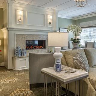 A cozy and modern living room featuring a fireplace, elegant lighting, and comfortable seating.