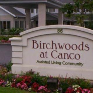 Sign reading 'Birchwoods at Canco Assisted Living Community' in front of a building.