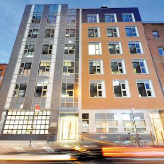 A modern building showcasing a mix of architectural styles in an urban setting.
