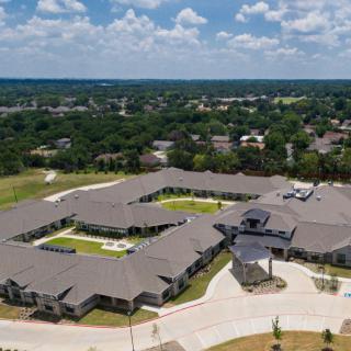 Aerial view of a large residential building complex in a suburban area.