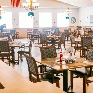 An empty restaurant dining area with arranged tables and chairs.
