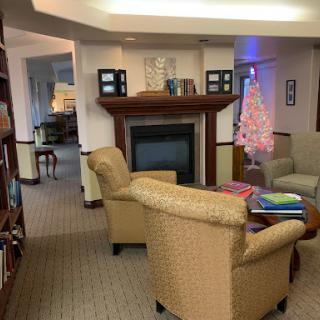 A cozy living room featuring comfortable seating, a fireplace, and decorative elements.