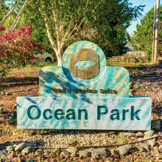 Entrance sign for Ocean Park surrounded by nature.
