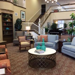 A spacious and elegantly designed lobby with comfortable seating and a modern staircase.