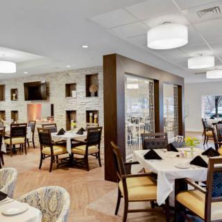 A modern and elegant restaurant dining area with neatly arranged tables and stylish decor.