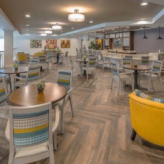 A vibrant and stylish dining area featuring modern furniture and a welcoming atmosphere.